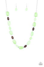 Load image into Gallery viewer, Varying in opacity, a mixed assortment of faceted Apple Green beads delicately link with dainty wooden beads across the chest, creating a whimsically earthy display. Features an adjustable clasp closure. 
