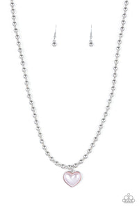  Featuring a pearly pink center, a charming heart pendant suspends from a strand of silver beads below the collar for a romantic flair. Features an adjustable clasp closure.
