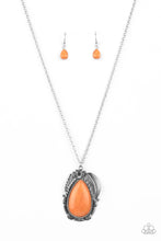 Load image into Gallery viewer, A silver feather, palm leaf, and dainty silver flower overlap atop an oversized orange stone teardrop that is nestled inside a textured scalloped frame, creating a dramatic pop of color at the bottom of a lengthened silver chain. Features an adjustable clasp closure. 
