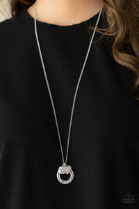 Dotted with a sparkly pink rhinestone, a dainty silver heart joins a silver ring stamped in the biblical passage, "Trust in the Lord with all thine heart," and a silver disc stamped in, "Proverbs 3:5," along the bottom of a lengthened silver chain, creating an inspirational pendant. Features an adjustable clasp closure.