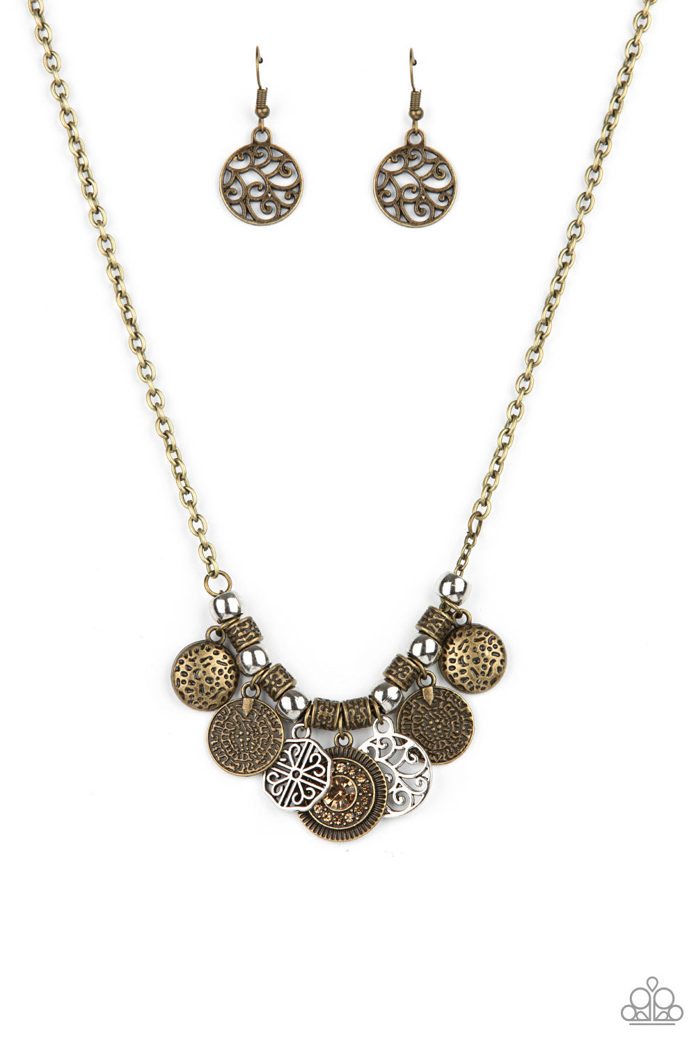 An antiqued collection of brass coin-like discs, silver vine-like frames, and hammered brass frames alternate with silver beads and ornate brass accents along the bottom of a classic brass chain. Dotted with golden topaz rhinestones, a sparkly frame adorns the center of the mismatched frames, adding a hint of sparkle to the rustic fringe. Features an adjustable clasp closure.