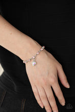 Load image into Gallery viewer, Brilliant pink rhinestones in shiny silver settings are linked together and accented with a charming iridescent rhinestone heart that dangles sweetly from the wrist. Features an adjustable clasp closure.
