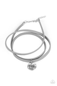 A bright hammered silver disc, embossed with the word "Faith" is threaded on a lengthened silver leather cord to wrap casually around the wrist and offer a message of hope. Features an adjustable clasp closure.