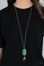 Load image into Gallery viewer, Encased in a classic silver fitting, a glassy jade stone swings from the bottom of a lengthened silver chain for an elegantly earthy look. A lobster clasp hangs from the bottom of the design to allow a name badge or other item to be attached. Features an adjustable clasp closure
