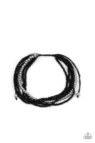 A single accent strand of silver beads merges with multiple strands of micro black beads for a simple yet trendy look. Features an adjustable sliding knot closure.