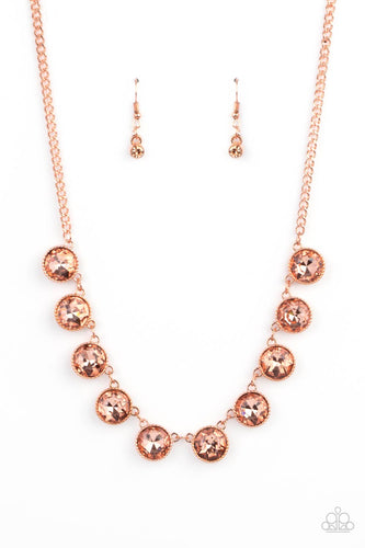 Featuring a mystical iridescence, a sparkling display of round cut coppery gems are encased in delicately textured copper frames as they link below the collar, creating a majestic statement piece. Features an adjustable clasp closure.  Sold as one individual necklace. Includes one pair of matching earrings.