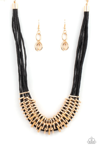 Bold and unapologetic, this hefty necklace gives off a hand-made feel with its multiple strands of black cording held together by industrial gold fittings that shift and slide. Features an adjustable clasp closure.