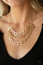 Load image into Gallery viewer, Three rows of gold chains with oversized hammered oval links attach to gold bars for an edgy display below the collar. Features an adjustable clasp closure.
