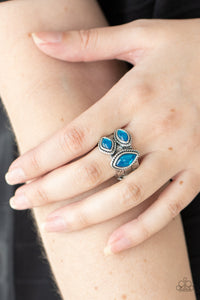 A trio of glassy blue marquise beads embellish the front of a hammered silver band etched in faux layers, creating an ethereal display atop the finger. Features a stretchy band for a flexible fit.