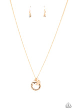 Load image into Gallery viewer, Dotted with a sparkly white rhinestone, a dainty gold heart joins a gold ring stamped in the biblical passage, &quot;Trust in the Lord with all thine heart,&quot; and a gold disc stamped in, &quot;Proverbs 3:5,&quot; along the bottom of a lengthened gold chain, creating an inspirational pendant. Features an adjustable clasp closure.
