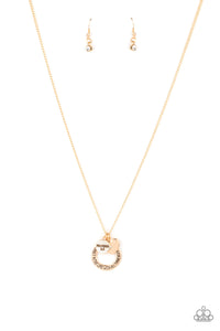 Dotted with a sparkly white rhinestone, a dainty gold heart joins a gold ring stamped in the biblical passage, "Trust in the Lord with all thine heart," and a gold disc stamped in, "Proverbs 3:5," along the bottom of a lengthened gold chain, creating an inspirational pendant. Features an adjustable clasp closure.