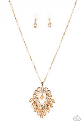 An oversized scalloped teardrop frame, tipped on its point, encases rows of sparkling white rhinestones in its lustrous gold fittings. Shimmery faceted champagne teardrop beads dangle daintily from the scalloped frame for an exquisitely eye-catching pendant at the end of a lengthened gold chain.  Features an adjustable clasp closure. 