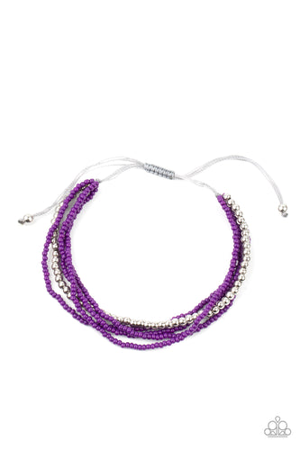 A single accent strand of silver beads merges with multiple strands of purple seed beads for a simple yet trendy look. Features an adjustable sliding knot closure. 