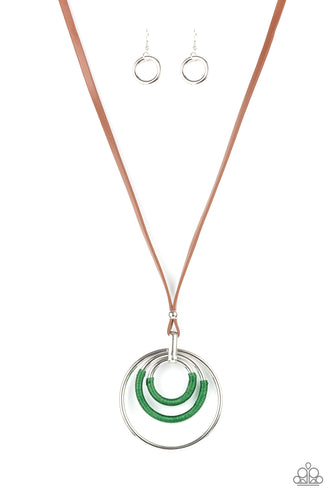 An impressive set of thick silver hoops is held together in concentric fashion by a strong silver fitting. Boldly wrapped bright green thread accents two hoops as the hefty pendant suspends from a lengthened brown leather cord in a hypnotic display. Features an adjustable clasp closure.