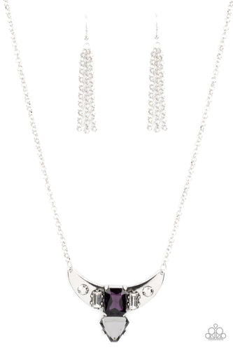 Pairs of faceted silver beads and glassy white emerald cut gems flank an oversized emerald cut purple gem atop an antiqued silver half moon frame. A smoky triangular cut gem adorns the bottom of the pendant, creating a twinkly talisman at the bottom of a classic silver chain. Features an adjustable clasp closure. 