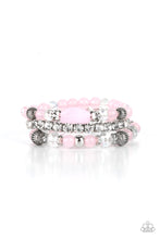 Load image into Gallery viewer, Infused with a stretchy strand of glassy white rhinestones, a mismatched collection of cloudy pink, white crystal-like, and ornate silver accents are threaded along stretchy bands around the wrist, creating ethereal layers. 
