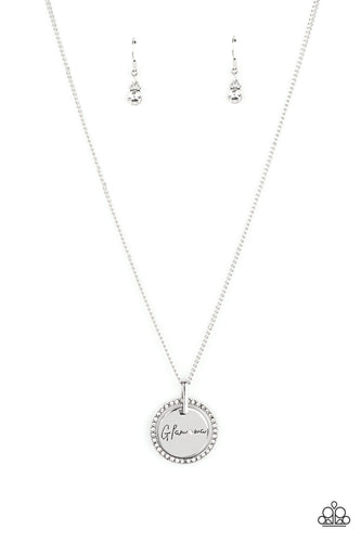 Infused with a silver ring of glassy white rhinestones, a glistening silver disc is dotted with a dainty white rhinestone and stamped in the word, 