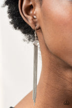 Load image into Gallery viewer, Dainty silver snake-like chains stream from the bottom of a glittery white rhinestone, creating a tapered tassel. Earring attaches to a standard fishhook fitting.
