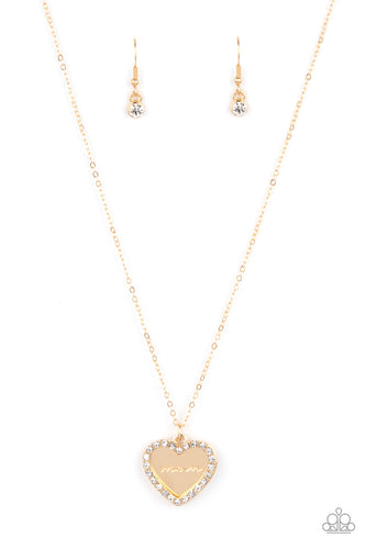 Infused with a glassy white rhinestone encrusted gold heart, a gold heart shaped pendant is stamped in the word, 