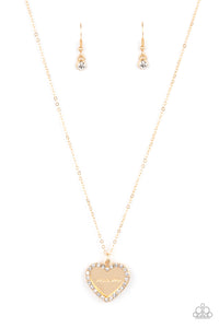 Infused with a glassy white rhinestone encrusted gold heart, a gold heart shaped pendant is stamped in the word, "Mom," as it swings below the collar, creating a sparkly sentimental statement piece. Features an adjustable clasp closure.