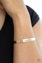 Load image into Gallery viewer, A dainty gold cuff is stamped in a heart and the word, &quot;Mother,&quot; creating a sentimental centerpiece around the wrist
