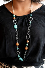 Load image into Gallery viewer, A mismatched assortment of turquoise stones, wooden beads, and silver accents sporadically adorn a double-linked silver chain, creating an earthy display across the chest. Features an adjustable clasp closure.  Sold as one individual necklace. Includes one pair of matching earrings.  New Kit Fashion Fix
