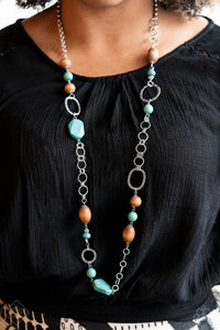 A mismatched assortment of turquoise stones, wooden beads, and silver accents sporadically adorn a double-linked silver chain, creating an earthy display across the chest. Features an adjustable clasp closure.  Sold as one individual necklace. Includes one pair of matching earrings.  New Kit Fashion Fix