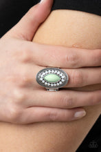 Load image into Gallery viewer, A silver frame embellished with dewy white beads and studded silver texture creates a stunning backdrop for a Green Ash marquise cut bead as it sits atop the finger. Features a stretchy band for a flexible fit.
