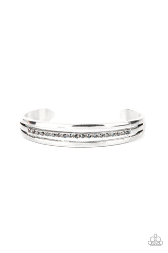Two glistening silver bars flank a row of smoky hematite rhinestones, coalescing into a dainty layered cuff around the wrist for a dash of refined edge. 