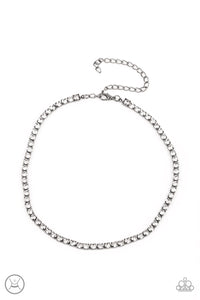 A strand of brilliant white rhinestones set in classic gunmetal fittings creates a stunningly radiant display across the collar. Features an adjustable clasp closure.