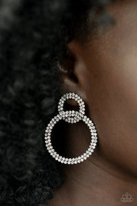 Rows of sparkly white rhinestones encircle into two interconnected hoops, creating a jaw-dropping lure. Earring attaches to a standard post fitting.  Sold as one pair of post earrings.