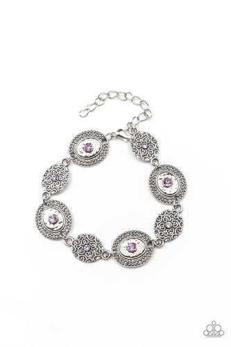 Delicate Amethyst Orchid rhinestones dot the centers of engraved antiqued silver discs. The dotted textures and heart shaped vines create a charming impression as they gracefully link around the wrist. Features an adjustable clasp closure.