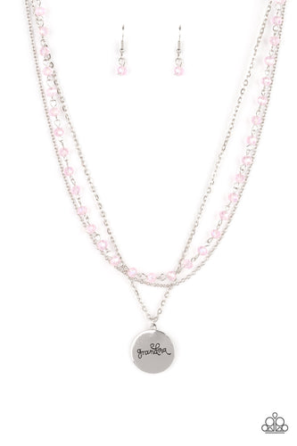 Infused with a strand of iridescent pink crystal-like beads, two dainty rows of mismatched silver chains delicately layer below the collar. Stamped in the word, 