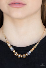 Load image into Gallery viewer, Varying in opacity, an enchanting collection of iridescent and crystal-like beads are threaded along an invisible wire that is attached to a gold chain below the collar. Mismatched gold beads and ornate gold accents are sprinkled between the glittery compilation, adding a whimsy sheen to the colorful statement piece. Features an adjustable clasp closure.
