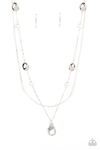 A dainty silver chain adorned in trios of iridescent flecked crystal-like beads layers with a chain dotted with matching crystal-like accents and imperfect silver and pearly white beads across the chest for a refined flair. A lobster clasp hangs from the bottom of the design to allow a name badge or other item to be attached. Features an adjustable clasp closure.  Sold as one individual lanyard. Includes one pair of matching earrings.