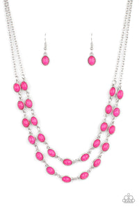 Encased in studded silver frames, two rows of oval pink stones delicately connect below the collar for a vivacious pop of color. Features an adjustable clasp closure.