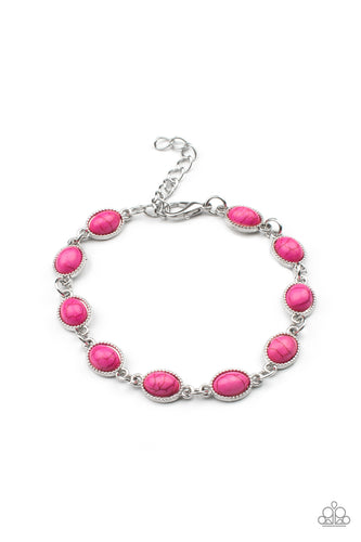 Encased in studded silver frames, oval pink stones delicately connect around the wrist for a vivacious pop of color. Features an adjustable clasp closure.