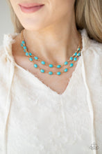 Load image into Gallery viewer, Encased in studded gold frames, two rows of oval turquoise stones delicately connect below the collar for a seasonal flair. Features an adjustable clasp closure. 
