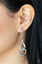 Load image into Gallery viewer, A glittery white rhinestone teardrop frame links with a shiny silver ring, creating a timeless lure. Earring attaches to a standard fishhook fitting. 
