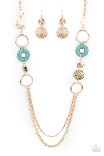 An earthy collection of hammered gold discs, turquoise stone accents, and bold gold hoops link with sections of chunky and mismatched gold chains across the chest, creating a seasonal display. Features an adjustable clasp closure.