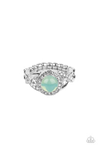 An opal green bead is pressed into the center of a ring of white rhinestones that sits atop interwoven silver bars dotted in dainty white rhinestones, creating an ethereally elegant centerpiece atop the finger. Features a dainty stretchy band for a flexible fit.