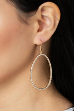 Load image into Gallery viewer, Dotted in dainty white rhinestones, an asymmetrical oval gold frame swings from the ear for a sassy look. Earring attaches to a standard fishhook fitting. 
