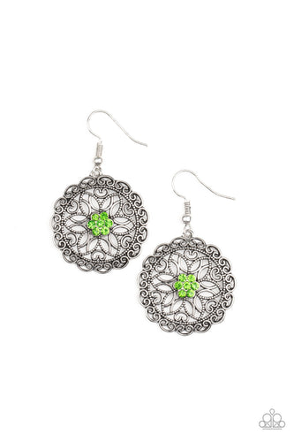 Overlapping silver petals fan out from a sparkly green rhinestone center inside a frilly ring of silver filigree, resulting in a whimsical floral frame. Earring attaches to a standard fishhook fitting. 