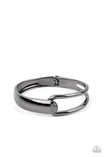 Load image into Gallery viewer, A flat gunmetal bar and airy gunmetal frame delicately overlap around the wrist, creating an oversized cuff-like bangle for a modern twist. Features a hinged closure.
