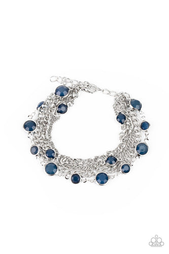Infused with glassy blue beaded strands, layers of mismatched silver chains drape around the wrist for an ethereal pop of color. Features an adjustable clasp closure.