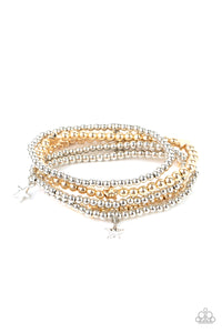 Infused with dainty gold star beads and shiny silver star charms, strands of gold and silver beaded stretchy bands stack across the wrist, creating a patriotic shimmer. 