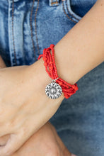 Load image into Gallery viewer, A shiny silver floral charm glides along stretchy strands of mismatched red seed beads, creating vibrant layers around the wrist.  Sold as one individual bracelet.
