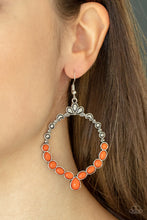 Load image into Gallery viewer, Ornate floral motifs decorate the top half of an airy circular silver frame. A row of dewy orange oval and round beads creates a border along the lower half of the frame, culminating in a single teardrop accent for a demurely enchanting lure. Earring attaches to a standard fishhook fitting. 

