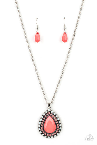 A faceted pink teardrop is pressed into the center of a silver frame bordered in rows of opalescent white and pink beads, creating an ethereal pendant at the bottom of a classic silver chain. Features an adjustable clasp closure. 