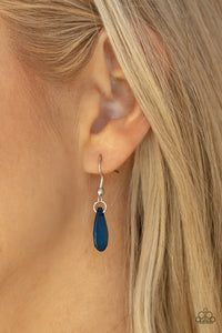 Encased in sleek silver fittings, a chain of faceted blue teardrops gives way to an oversized blue teardrop pendant for an enchanting pop of color below the collar. Features an adjustable clasp closure. 